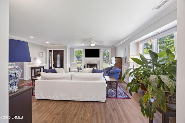 51 White Oaks Cir, Bluffton, SC 29910 - living area with a ceiling fan, ornamental molding, a fireplace, wood finished floors, and recessed lighting