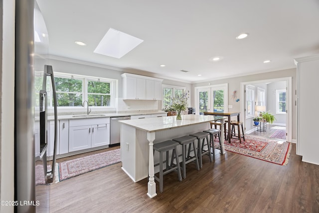 51 White Oaks Cir, Bluffton, SC 29910 - kitchen featuring a sink, stainless steel appliances, ornamental molding, white cabinetry, and a kitchen island