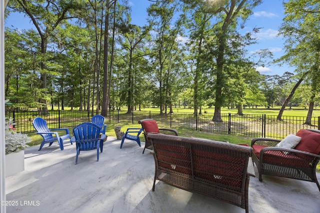 51 White Oaks Cir, Bluffton, SC 29910 - fenced backyard featuring a patio, outdoor lounge area, and view of wooded area