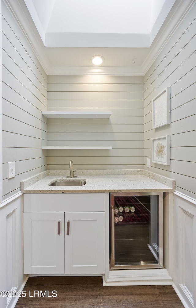 51 White Oaks Cir, Bluffton, SC 29910 - indoor wet bar with ornamental molding, dark wood-type flooring, beverage cooler, a decorative wall, and wooden walls