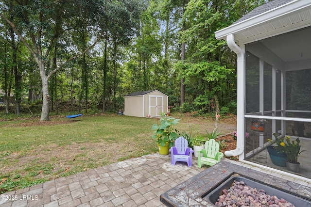 29 Wiregrass Way, Bluffton, SC 29910 - view of green lawn featuring a storage unit, a patio area, an outdoor structure, a sunroom, and an outdoor fire pit