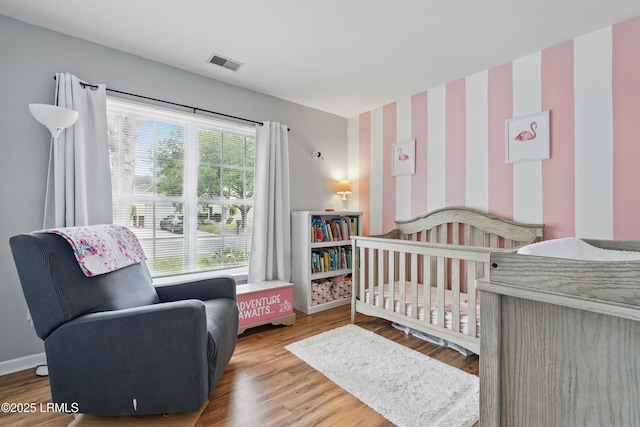 29 Wiregrass Way, Bluffton, SC 29910 - bedroom with wallpapered walls, baseboards, wood finished floors, and a crib