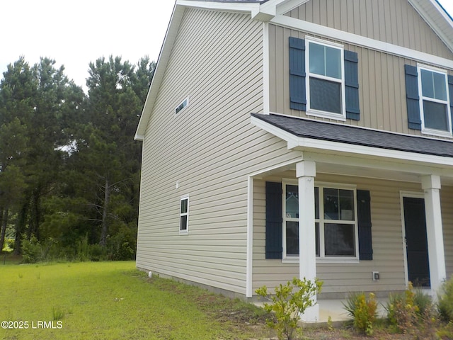 127 Teal Bluff Blvd, Seabrook, SC 29940 - view of side of home featuring board and batten siding and a yard