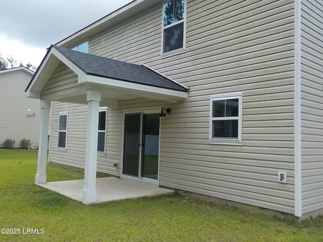 127 Teal Bluff Blvd, Seabrook, SC 29940 - back of property featuring a patio, a lawn, and a shingled roof