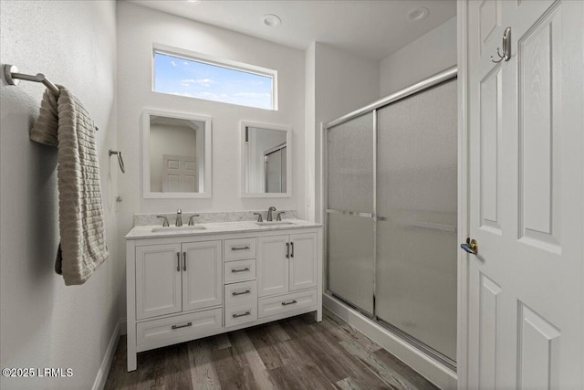 61 Hampton Cir, Bluffton, SC 29909 - full bath with double vanity, wood finished floors, a shower with door, and baseboards