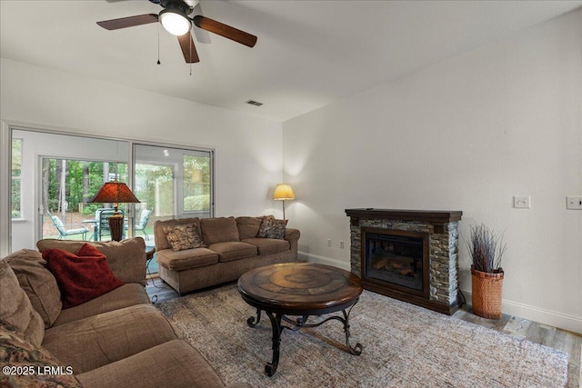 61 Hampton Cir, Bluffton, SC 29909 - living room with baseboards, ceiling fan, wood finished floors, and a fireplace
