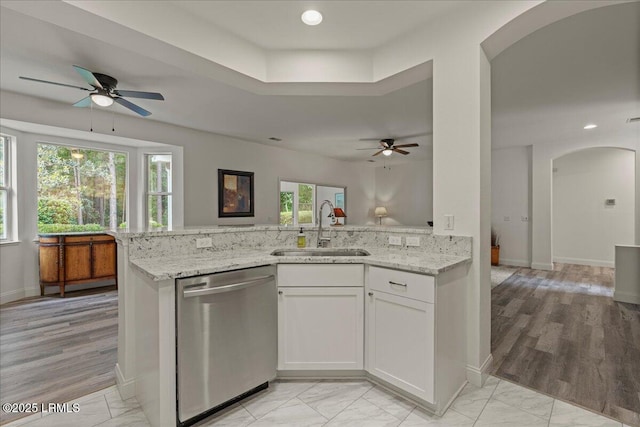 61 Hampton Cir, Bluffton, SC 29909 - kitchen featuring dishwasher, a sink, arched walkways, ceiling fan, and light stone countertops
