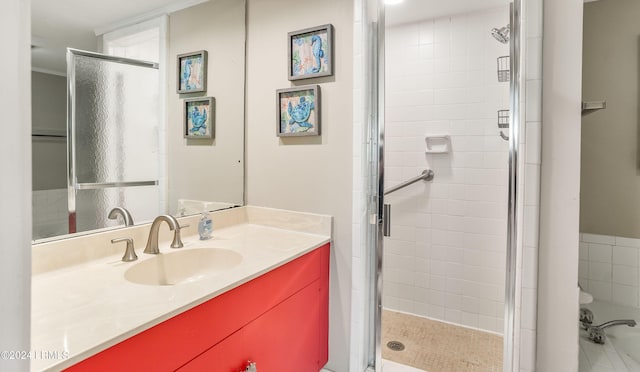 bathroom with a shower with door and vanity