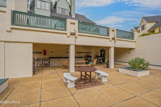 view of patio featuring a balcony