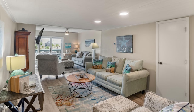 living room featuring crown molding, hardwood / wood-style floors, and ceiling fan