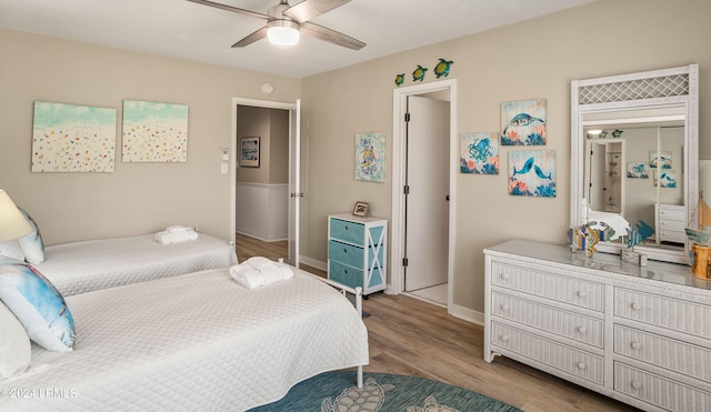 bedroom with light hardwood / wood-style flooring and ceiling fan