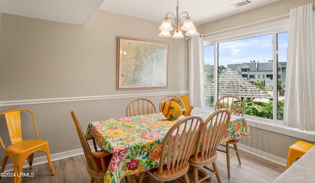 dining area featuring a notable chandelier and wood-type flooring