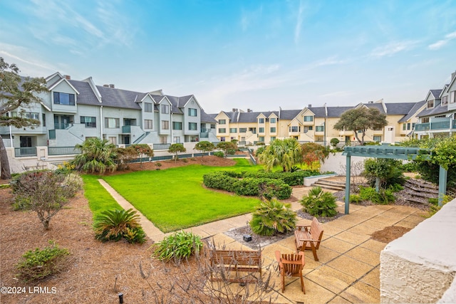 view of community with a pergola and a lawn