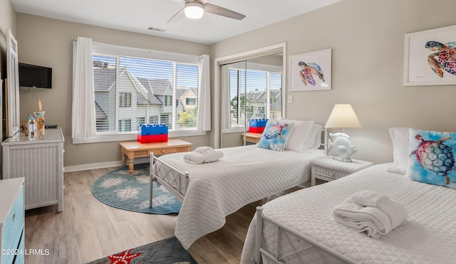 bedroom featuring light hardwood / wood-style flooring, a closet, and ceiling fan