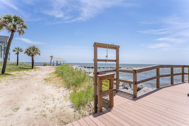 view of dock featuring a gazebo, a water view, and a view of the beach