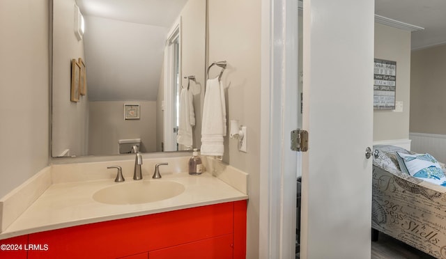 bathroom featuring vanity, crown molding, and toilet