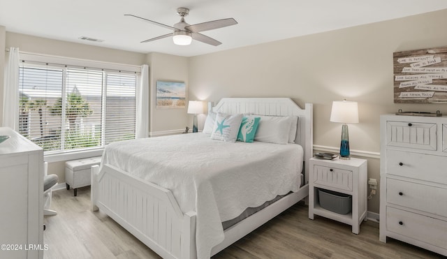 bedroom with light hardwood / wood-style flooring and ceiling fan