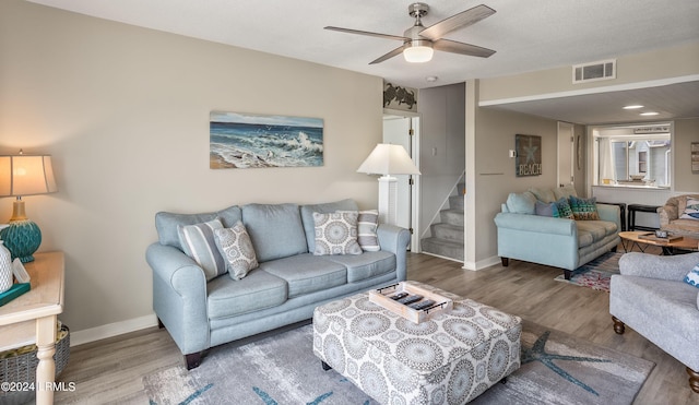 living room featuring hardwood / wood-style flooring and ceiling fan