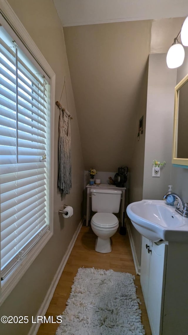 802 12th St, Port Royal, SC 29935 - bathroom with vanity, wood finished floors, toilet, and healthy amount of natural light