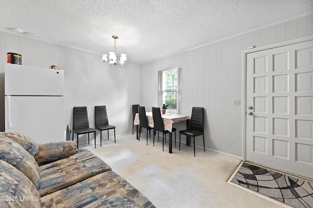 400 William Hilton Pkwy Unit 110, Hilton Head Island, SC 29926 - carpeted living area with a chandelier, a textured ceiling, and ornamental molding