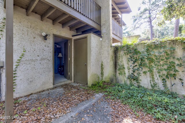 400 William Hilton Pkwy Unit 110, Hilton Head Island, SC 29926 - doorway to property featuring stucco siding and a balcony