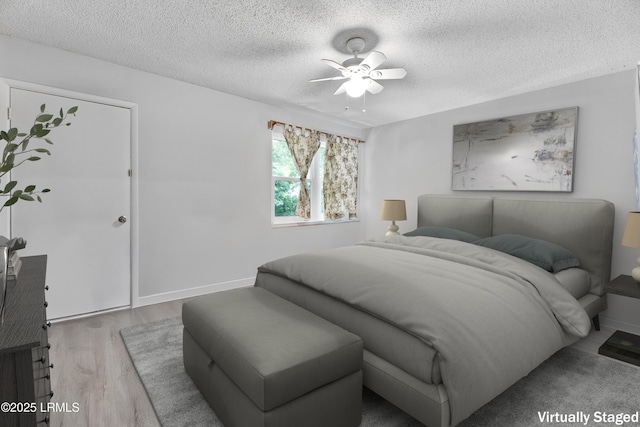 400 William Hilton Pkwy Unit 110, Hilton Head Island, SC 29926 - bedroom with wood finished floors, a textured ceiling, and a ceiling fan