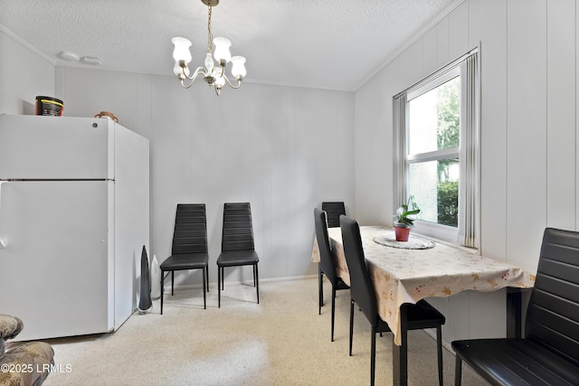 400 William Hilton Pkwy Unit 110, Hilton Head Island, SC 29926 - dining room featuring a textured ceiling, ornamental molding, and a chandelier