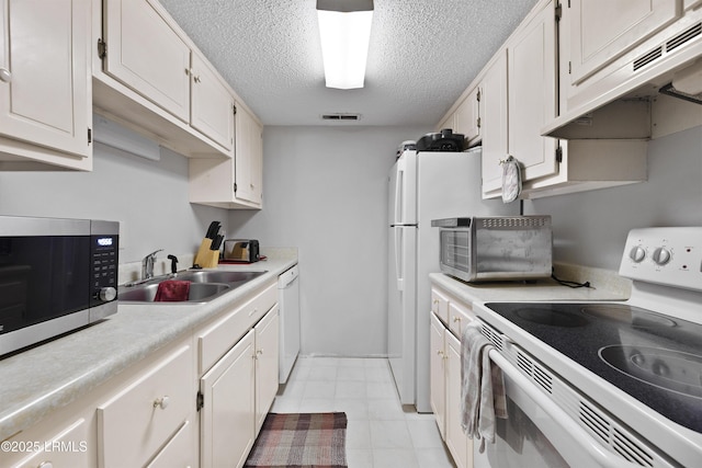 400 William Hilton Pkwy Unit 110, Hilton Head Island, SC 29926 - kitchen featuring white appliances, exhaust hood, light countertops, a textured ceiling, and white cabinets