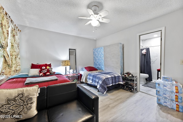 400 William Hilton Pkwy Unit 110, Hilton Head Island, SC 29926 - bedroom featuring wood finished floors, a textured ceiling, connected bathroom, and ceiling fan