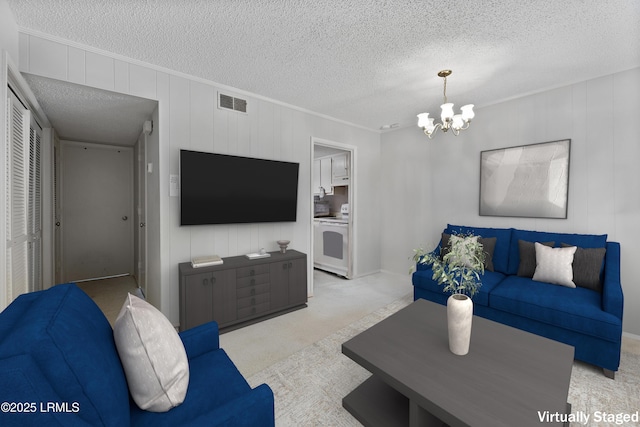 400 William Hilton Pkwy Unit 110, Hilton Head Island, SC 29926 - living room featuring a chandelier, carpet flooring, a textured ceiling, and crown molding