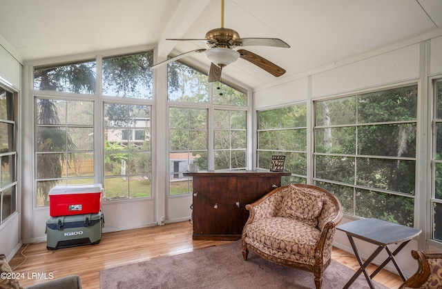 sunroom featuring lofted ceiling with beams, a wealth of natural light, and ceiling fan