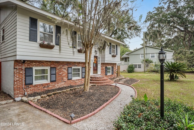 raised ranch with a front yard