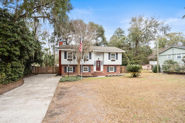 raised ranch featuring a front lawn