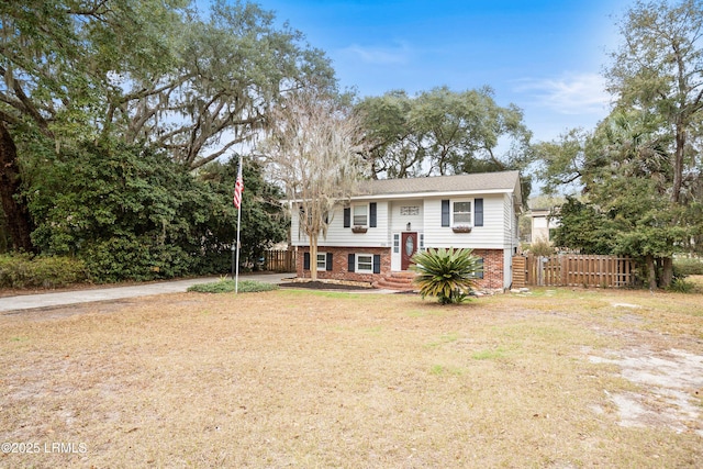 raised ranch with a front yard