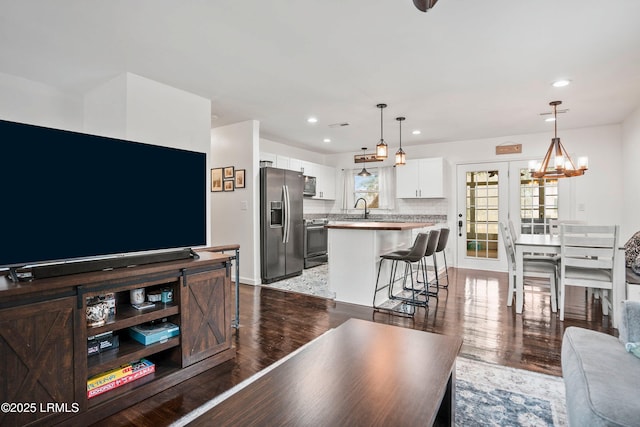 living room featuring french doors, dark hardwood / wood-style floors, and sink