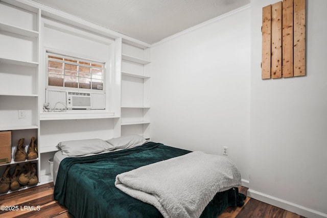 bedroom featuring cooling unit, dark hardwood / wood-style flooring, and crown molding