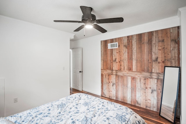 bedroom featuring crown molding, ceiling fan, and dark hardwood / wood-style floors