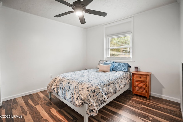 bedroom featuring ceiling fan, dark hardwood / wood-style flooring, and a textured ceiling