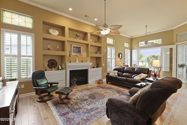 102 Lake Somerset Cir, Bluffton, SC 29909 - living room with crown molding, ceiling fan, light wood finished floors, built in features, and a fireplace with flush hearth