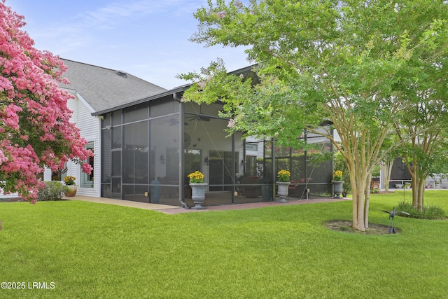 102 Lake Somerset Cir, Bluffton, SC 29909 - rear view of house featuring a lawn, a sunroom, and roof with shingles