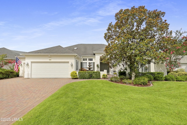 102 Lake Somerset Cir, Bluffton, SC 29909 - view of front of house featuring decorative driveway, an attached garage, stucco siding, and a front lawn