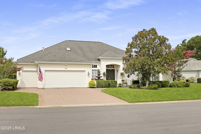 102 Lake Somerset Cir, Bluffton, SC 29909 - view of front of property with a garage, decorative driveway, a front lawn, stucco siding, and roof with shingles