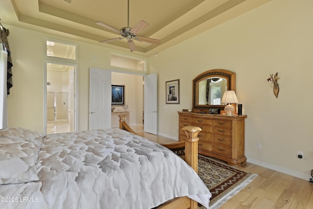 102 Lake Somerset Cir, Bluffton, SC 29909 - bedroom with a raised ceiling, light wood-style floors, ensuite bathroom, ceiling fan, and a high ceiling