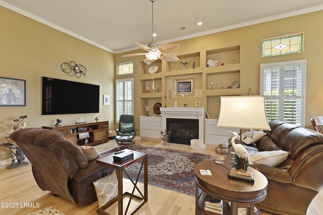 102 Lake Somerset Cir, Bluffton, SC 29909 - living room with crown molding, built in shelves, light wood-style floors, a ceiling fan, and recessed lighting