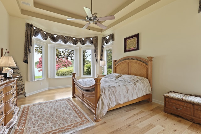 102 Lake Somerset Cir, Bluffton, SC 29909 - bedroom with a raised ceiling, light wood finished floors, and a ceiling fan