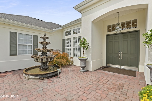 102 Lake Somerset Cir, Bluffton, SC 29909 - view of exterior entry with stucco siding and roof with shingles