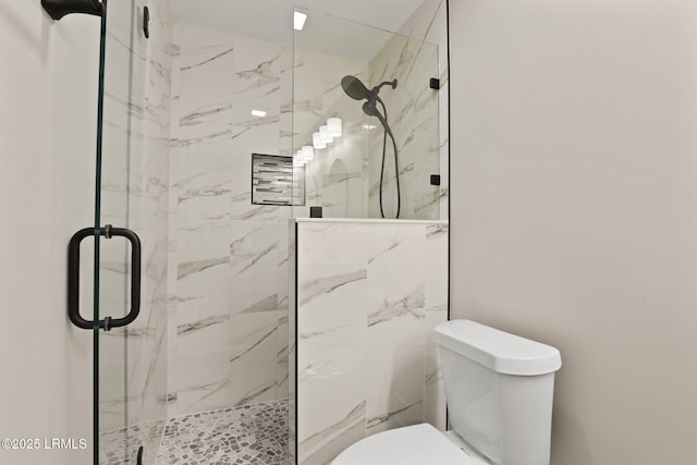 full bath featuring a marble finish shower and toilet