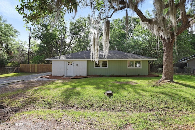 back of property featuring a yard and fence