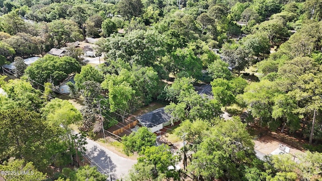 drone / aerial view with a wooded view