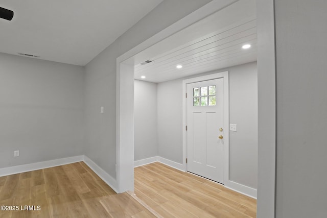 entryway featuring baseboards, recessed lighting, light wood-style flooring, and visible vents